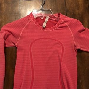 Long sleeve pink lululemon shirt.